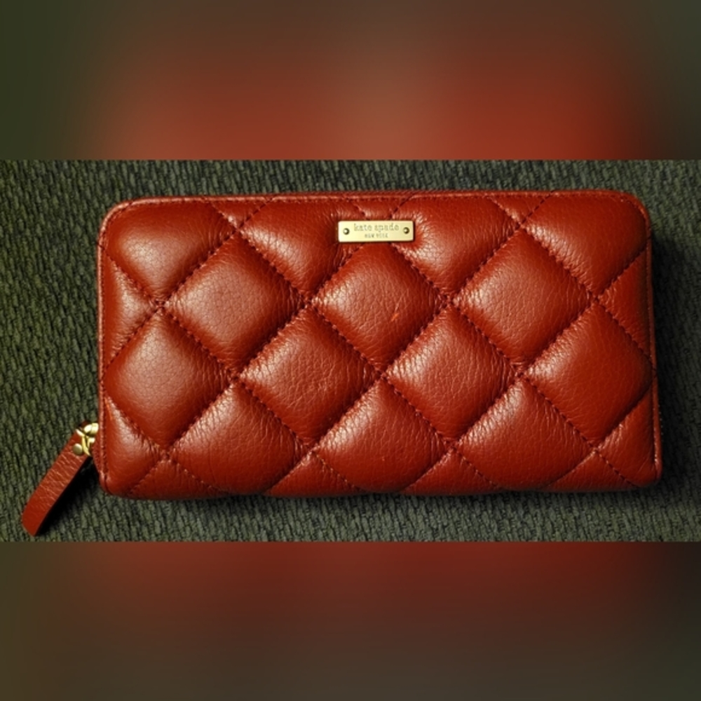 Kate Spade FEATURES 7.75"l x 1"w x 4"h quilted smooth leather 2 way spade jaquar